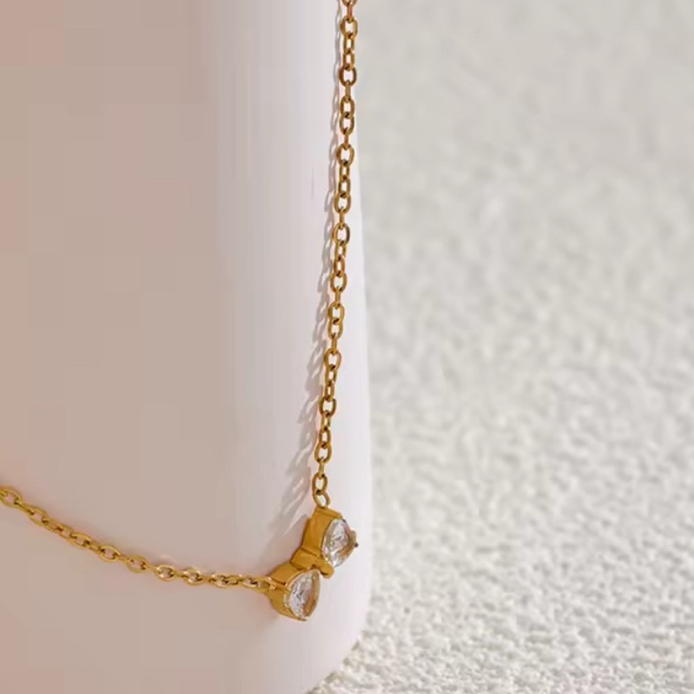 Stainless Steel, Gold Plated
Matching ring, sold separately 
Gold Bow Necklace